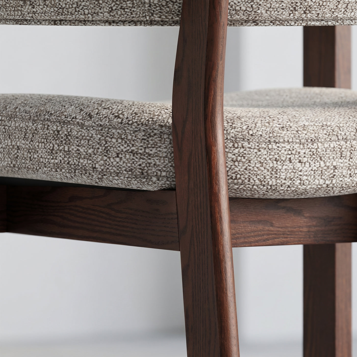 Close-up of mixed-weave seat fabric and solid red oak frame on the HALO Luxe chair