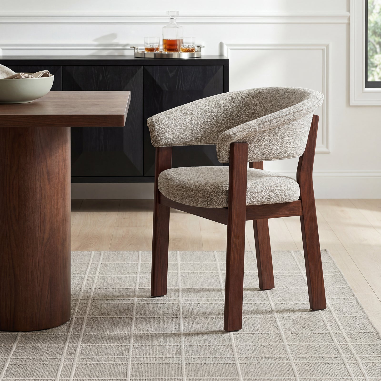 Beige and walnut COLAMY HALO Luxe dining chair beside a wood dining table